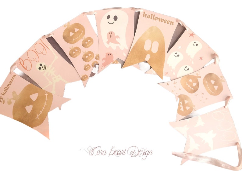 May include: A decorative bunting banner featuring pale pink triangular flags strung together. The flags display gold-toned illustrations of pumpkins, ghosts, skeletons, and bats, with the text BOO and halloween printed in a matching gold font.