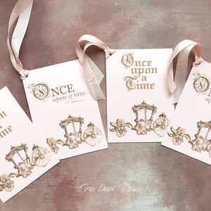 May include: Four pink and gold gift tags with the text "Once upon a time..." and a gold carriage illustration.