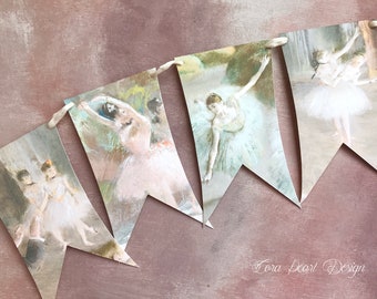 May include: A banner with five flags featuring images of ballerinas in various poses. The flags are made of paper and are strung together with white twine. The background is a light brown color.