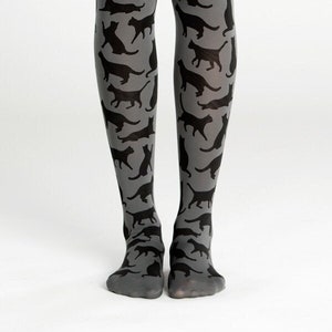 May include: Gray tights with a black cat silhouette pattern.