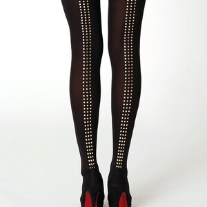 May include: Black tights with gold dot detailing on the back of the legs.