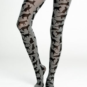 May include: Gray tights with a black cat silhouette pattern. The cat silhouettes are repeated throughout the tights.