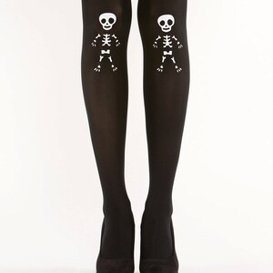 May include: Black tights with white skeleton designs on the thighs.