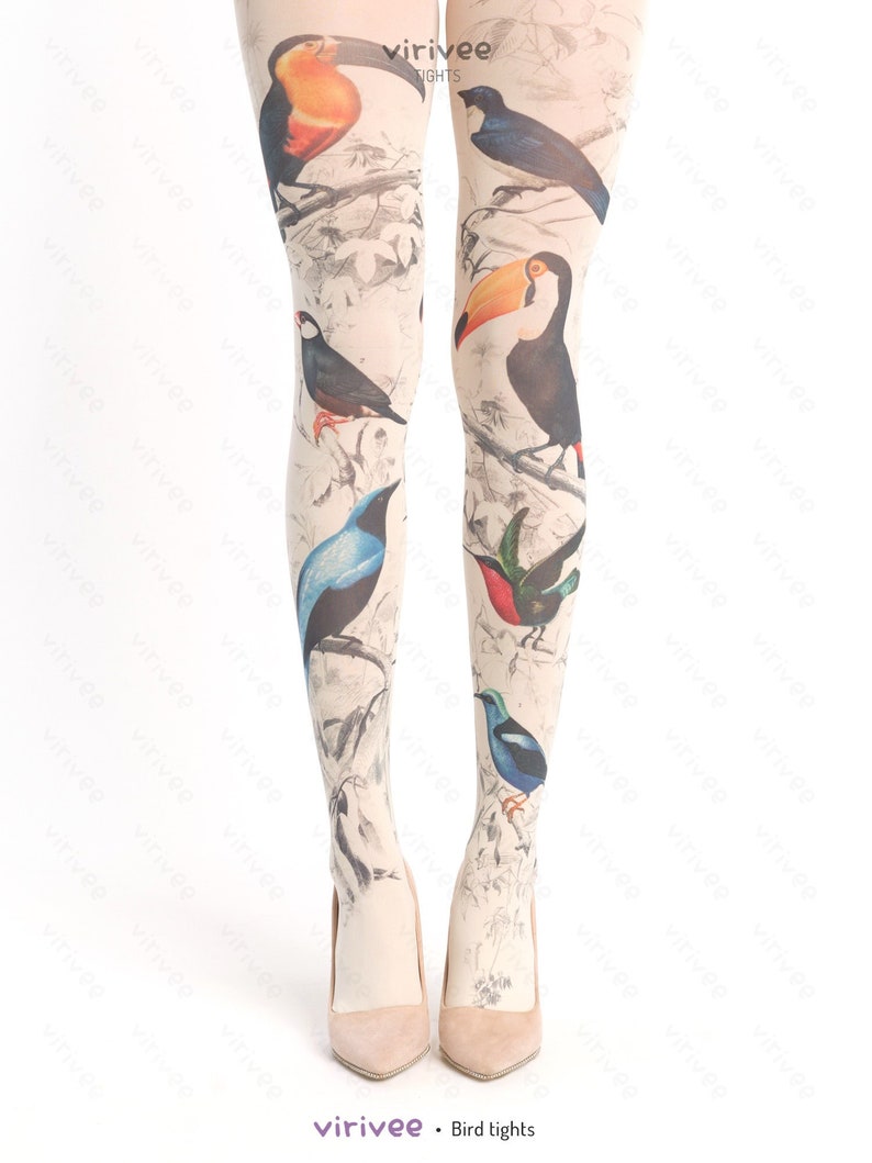 May include: Beige sheer tights with a bird print design. The birds are colorful and include toucans, bluebirds, and hummingbirds.