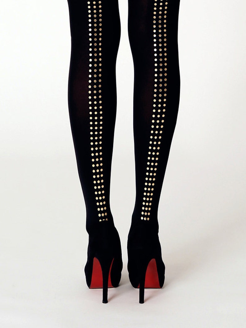 May include: Black tights with gold dot accents on the back of the legs. The tights are paired with black high heels with red soles.