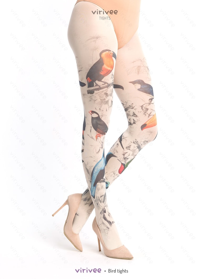 May include: A pair of sheer tights with a bird print design. The tights feature a variety of colorful birds, including toucans, hummingbirds, and other tropical birds. The background is a light beige color.