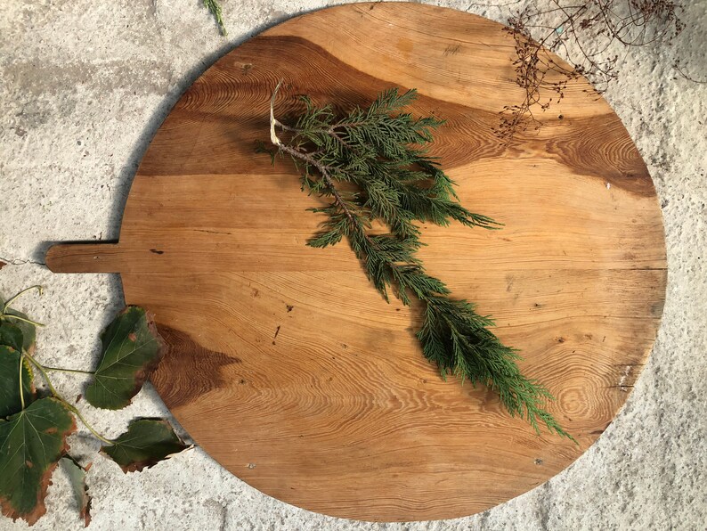 large circular wooden cutting board