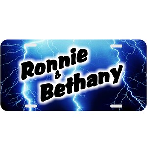 May include: A blue and black personalized license plate with a lightning bolt design and the text "Ronnie & Bethany".