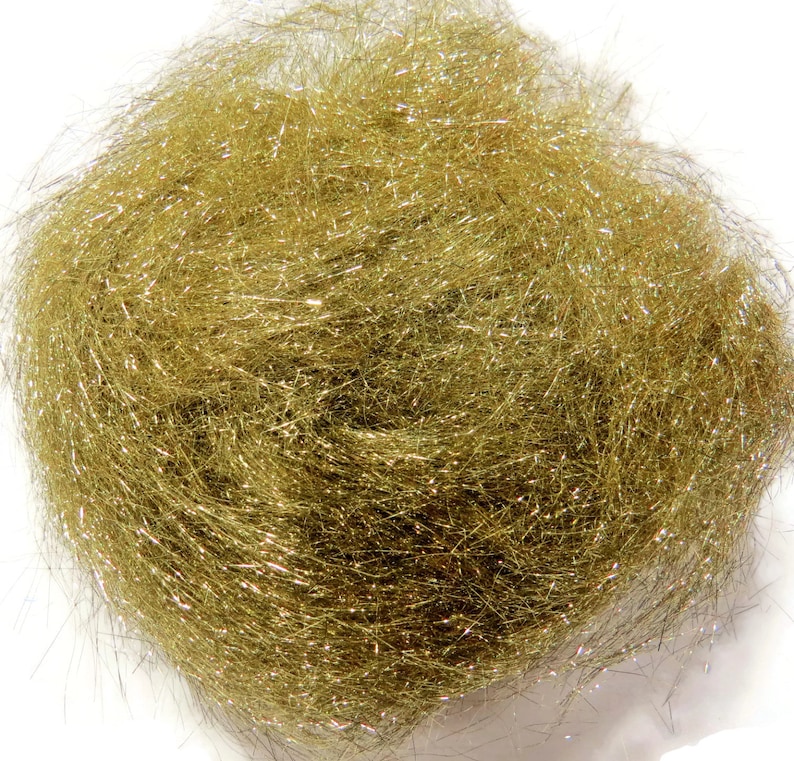 May include: A close-up of a bundle of gold metallic craft fiber. The fiber is very fine and has a slight shimmer.