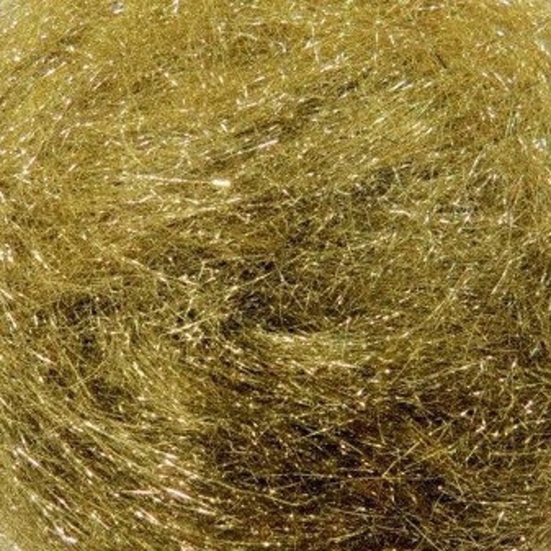 May include: A close-up of a spool of gold metallic fiber. The fiber is very fine and has a slight shimmer to it.