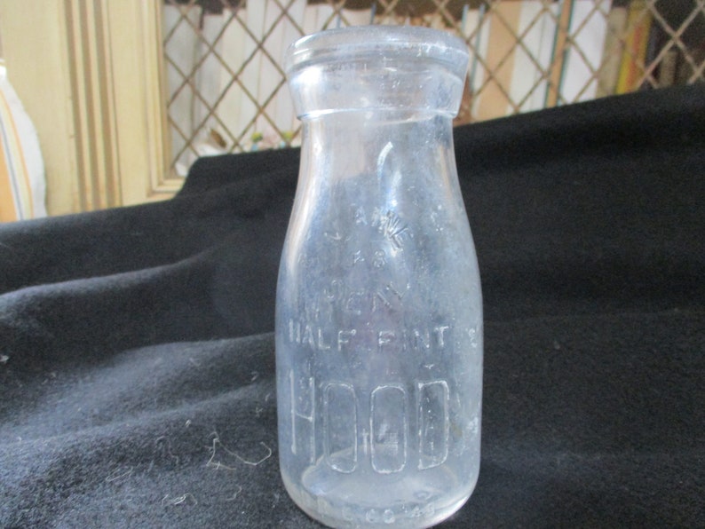 Embossed H.P. Hood & Sons, Dairy Experts. Uncommon half pint Maine 48 seal pint milk bottle. On the bottom is has Hood 1935. image 1