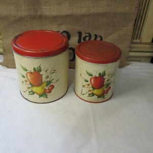 Set of 2 Decorware Canisters, Red Lid, Apple, Pear and Cherries, 6 3/4" tall with lid, and smaller 6" tall and 4 1/2" wide. Retro Kitchen.