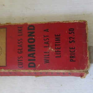 May include: Red cardboard box with black text that reads "Cuts Glass Like Diamond", "Will Last A Lifetime", and "Price $2.50".