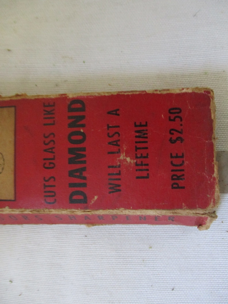 May include: Red cardboard box with black text that reads "Cuts Glass Like Diamond", "Will Last A Lifetime", and "Price $2.50".