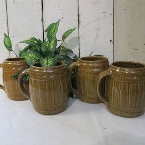 A set of 4 Vintage unmarked Pottery Barrel-shaped Brown glazed mugs.