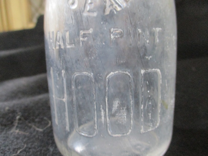 Embossed H.P. Hood & Sons, Dairy Experts. Uncommon half pint Maine 48 seal pint milk bottle. On the bottom is has Hood 1935. image 2