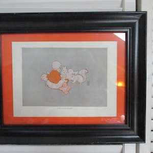 May include: A framed illustration of a child in a red dress sitting with three white kittens. The illustration is on a white background with a light gray wash. The frame is black with a red mat.