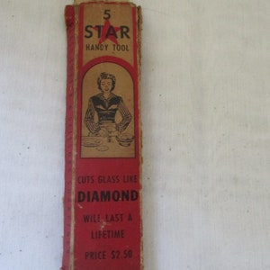 May include: Red and white cardboard box with a red star and the text "5 STAR HANDY TOOL". The box also has a black and white illustration of a woman using a tool to cut glass. The text "CUTS GLASS LIKE DIAMOND" is printed on the box, along with "WILL LAST A LIFETIME" and "PRICE $2.50".