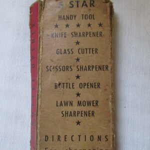 May include: A brown cardboard box with the text "5 STAR HANDY TOOL" and a list of tools it contains: "KNIFE SHARPENER", "GLASS CUTTER", "SCISSORS SHARPENER", "BOTTLE OPENER", and "LAWN MOWER SHARPENER".
