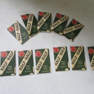 May include: Ten packs of Half and Half Burley and Bright tobacco. Each pack has a green background with white text and a red circle with the words "A Card of Commendation" inside.