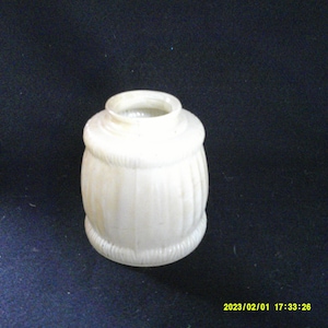 May include: A white glass lampshade with a ribbed design. The lampshade is approximately 4 inches tall and 3 inches wide.