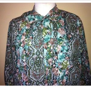 May include: A long-sleeved button-up shirt with a paisley and floral print in shades of green, blue, and pink.