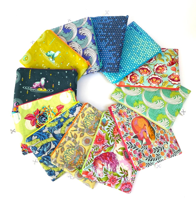 May include: A collection of 12 colorful zippered pouches with various patterns, including floral, geometric, and animal prints. The pouches are arranged in a circle on a white background.