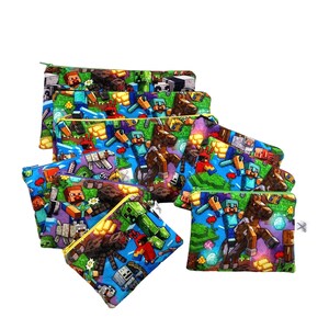 May include: A set of eight colorful zippered pouches with a Minecraft theme. The pouches feature a variety of characters and items from the popular video game, including Steve, Creeper, and a horse. The pouches are made of a soft, durable fabric and are perfect for storing small items like pencils, pens, and makeup.
