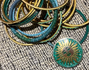 Beautiful bangle bracelet lot with sun brooch or pendant