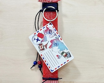 Red traditional candle decorated with travel keychain for Orthodox Easter Pascha as lambada