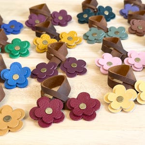 May include: A set of three ceramic mugs with a speckled, matte finish. The mugs are in shades of cream, light gray, and dark gray. Each mug has a simple, minimalist design, perfect for coffee or tea.