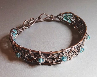 Woven copper bracelet with blue bicone beads