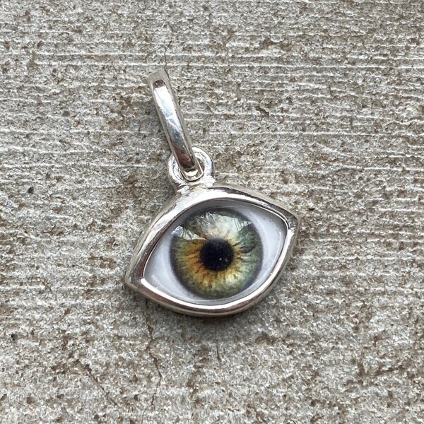 Mini bright blue hazel eye pendant in the updated Sterling Silver setting