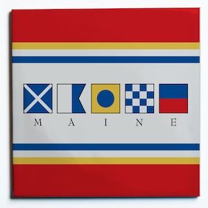 May include: Square artwork featuring nautical signal flags spelling "MAINE" in black letters. The design includes red, yellow, and blue horizontal stripes at the top and bottom. The flags are in a row, each with a unique design.