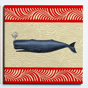 May include: A blue whale illustration on a canvas print. The whale is depicted with detailed linework, spouting water. The background features a beige wavy pattern, framed by a red border with a white scroll design. A nautical theme.
