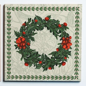 May include: Square tile featuring a detailed illustration of a Christmas wreath. The wreath is composed of green leaves and red berries, set against a light beige background with a subtle floral pattern. A green and red border frames the image.