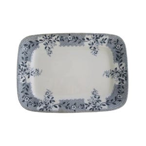 May include: A rectangular ceramic serving platter featuring a cream-colored center and a decorative border. The border displays a dark blue floral pattern with intricate vine details and a cross-hatched lattice texture along the edges.