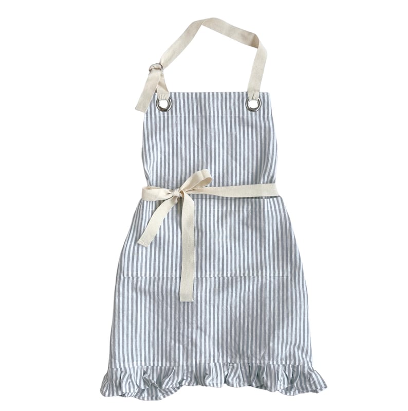 May include: A blue and white striped apron with a cream-colored neck strap and waist tie. The apron has a ruffled hem and metal grommets at the top. The apron is approximately 30 inches long.