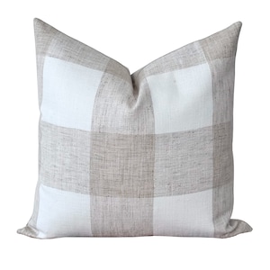 a white pillow with a checkered pattern on it