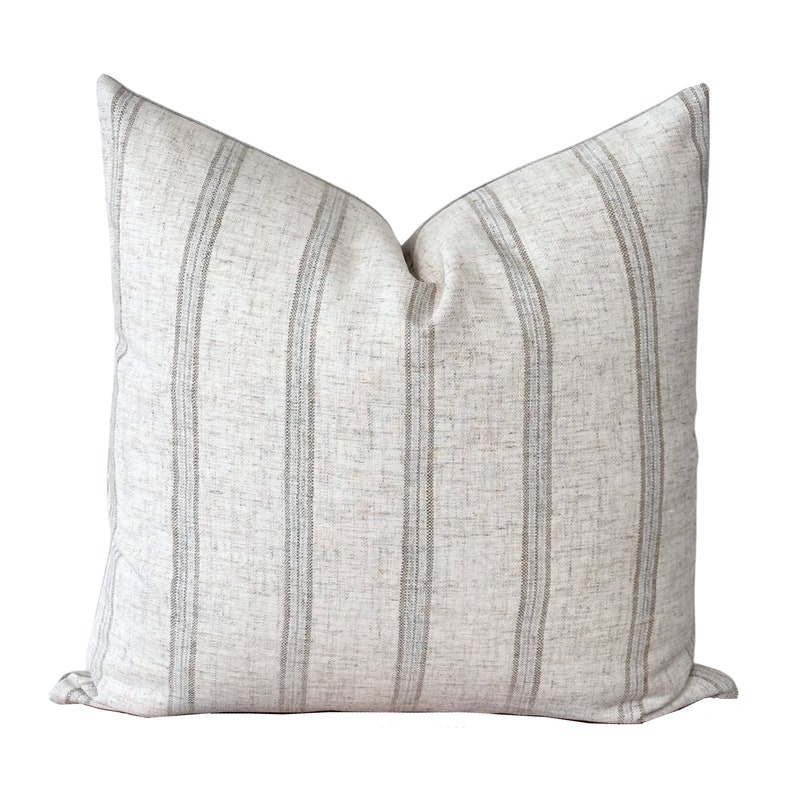 a white and grey striped pillow on a white background