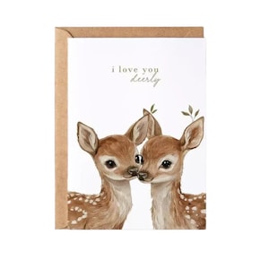 May include: A greeting card featuring a watercolor illustration of two fawn deer. The card has the text "i love you deerly" in a delicate script. The card is set against a brown paper envelope.