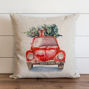 May include: A red vintage car with a Christmas tree on top and a gift box tied with a red ribbon. The car has a license plate that says "LUCKY".