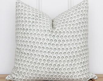 May include: A white pillow with a green floral pattern. The pillow is made of a soft, comfortable fabric and has a subtle sheen.