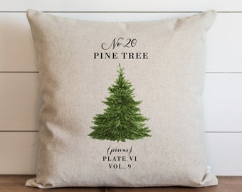 May include: A beige linen pillow with a green pine tree illustration and the text "No. 20 PINE TREE {pinus} PLATE VI VOL. 9"