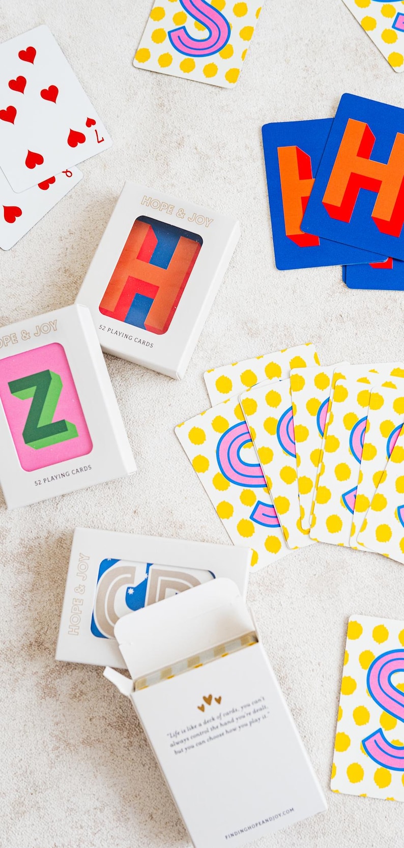 Custom playing cards with color and design options for the background, and personalized colors for letters.