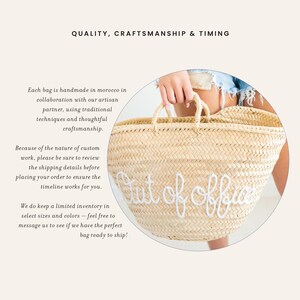 May include: Woven straw tote bag with white embroidered "Out of office" text. The bag has two handles and is held by a person. The bag is handmade in Morocco.