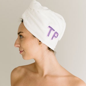 May include: White microfiber hair turban with the initials "TP" embroidered in purple.