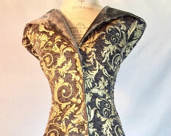 May include: A long, black and gold brocade dress with a collar and short sleeves. The dress has a button-up front and a fitted waist.