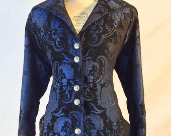 May include: A long, black and blue patterned coat with silver buttons. The coat has a fitted waist and a flared skirt.