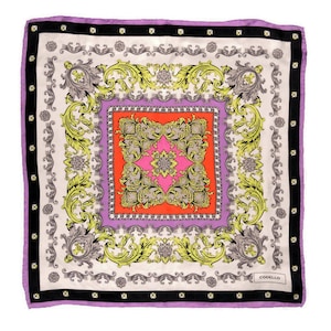 May include: Square silk scarf with a baroque design. The scarf features a central orange and pink square, surrounded by a lavender border and a cream-colored background with yellow and gray floral patterns. The edges are trimmed in lavender.